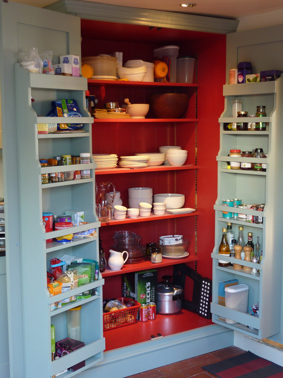 interior of handmade kitchen larder cupboard showing door racks