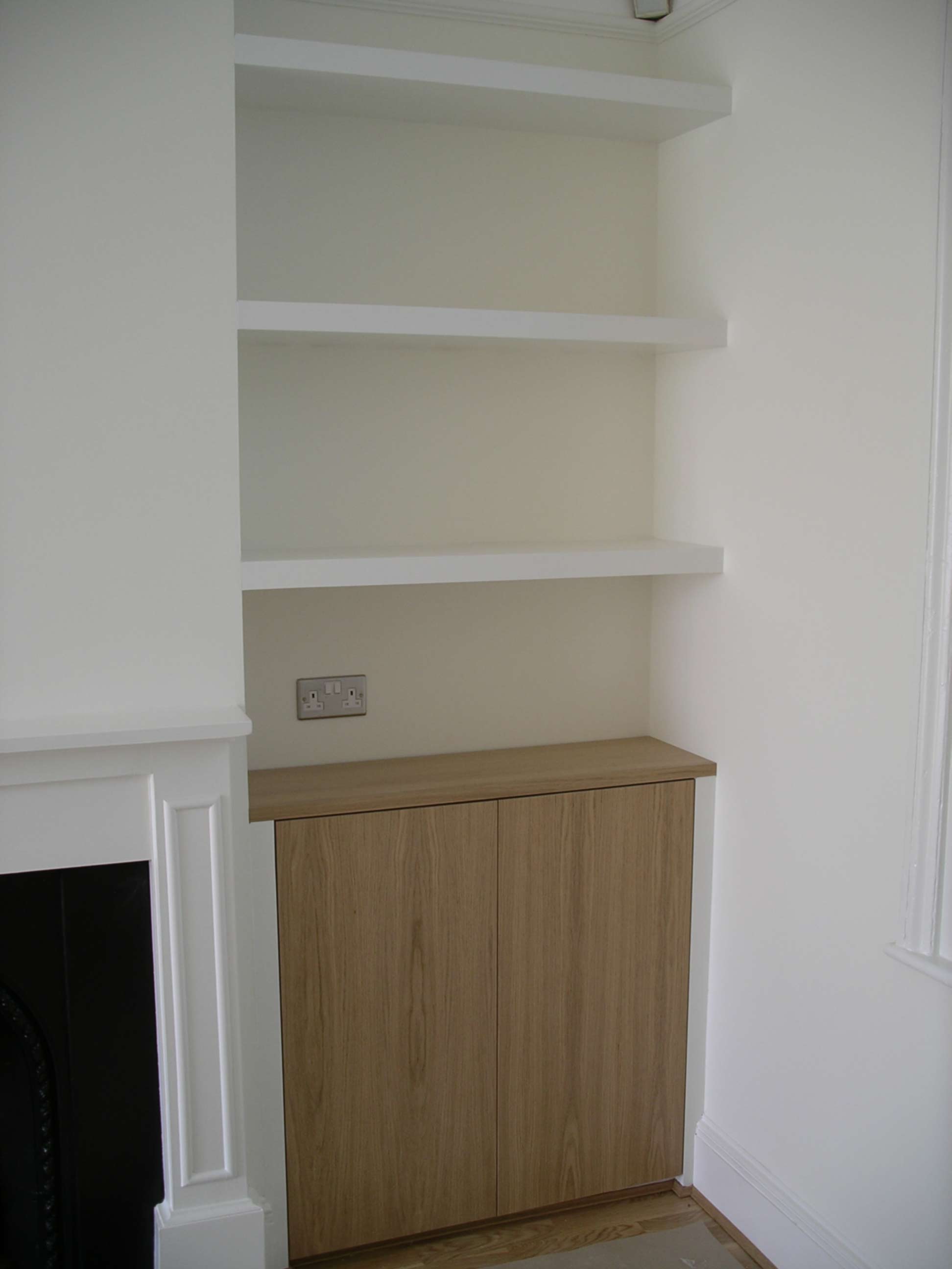 custom made alcove cupboard with oak doors and chubby shelves