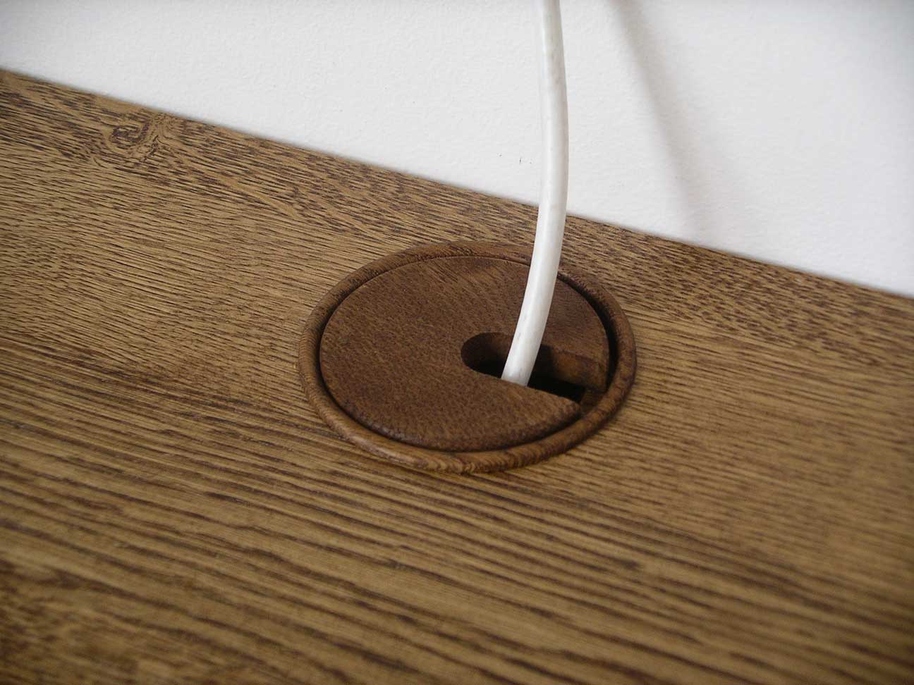 cable outlets in solid oak worktop on bespoke cabinet