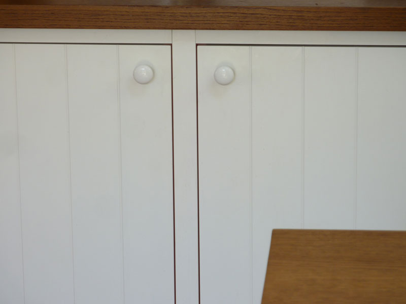 porcelain shaker knobs on tongue-and-groove doors