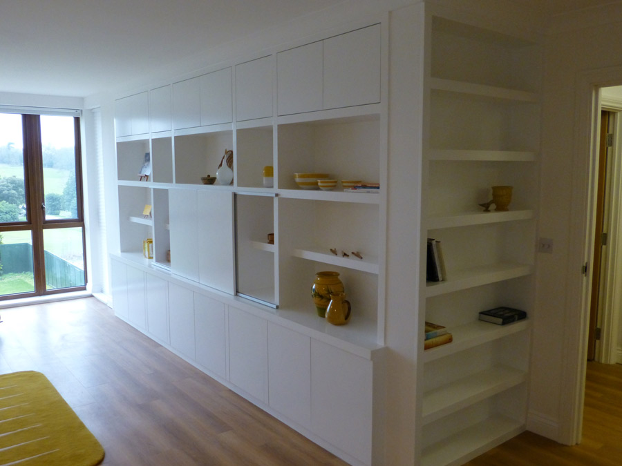 fitted bookcase with hidden television storage