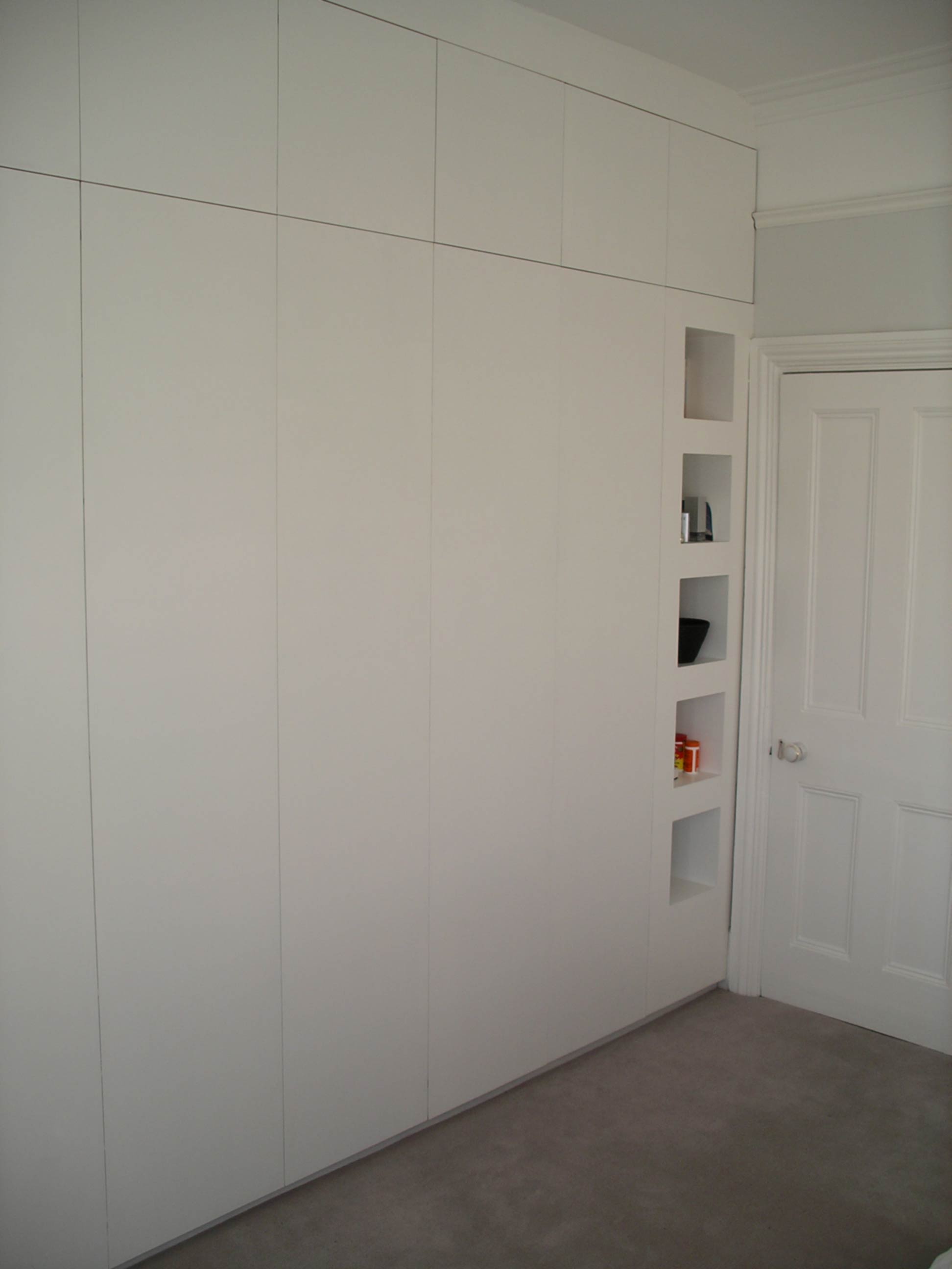 fitted wall to wall and floor to ceiling wardrobe