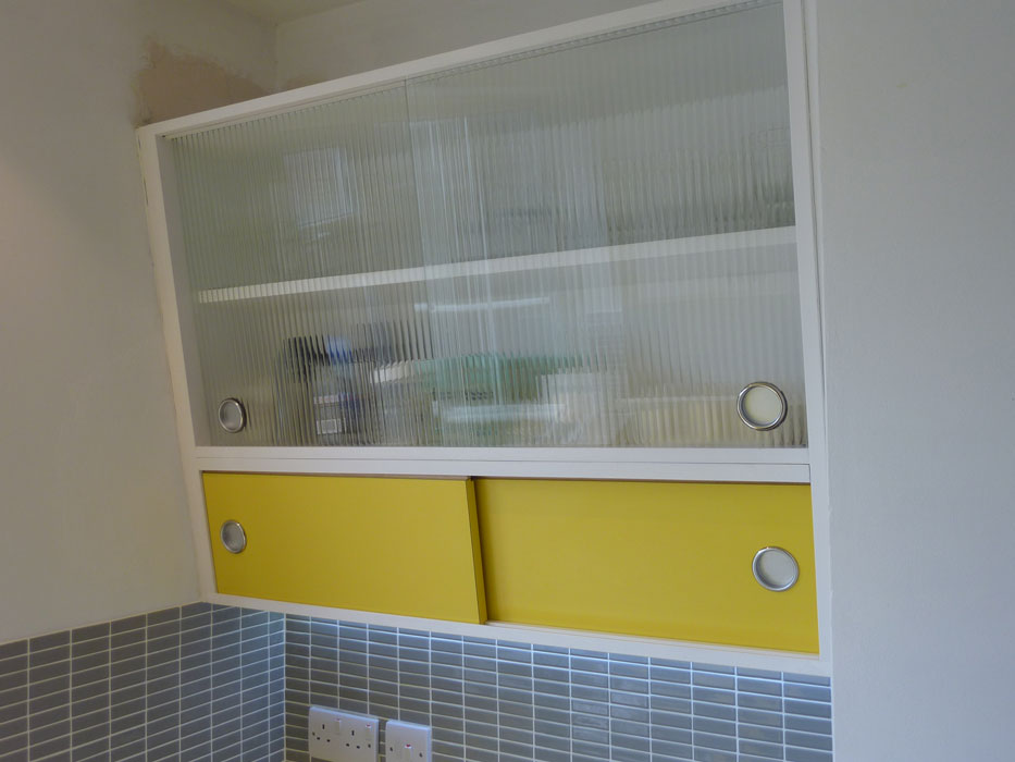 1950's style angled wall cabinet with formica and reeded glass doors custom made