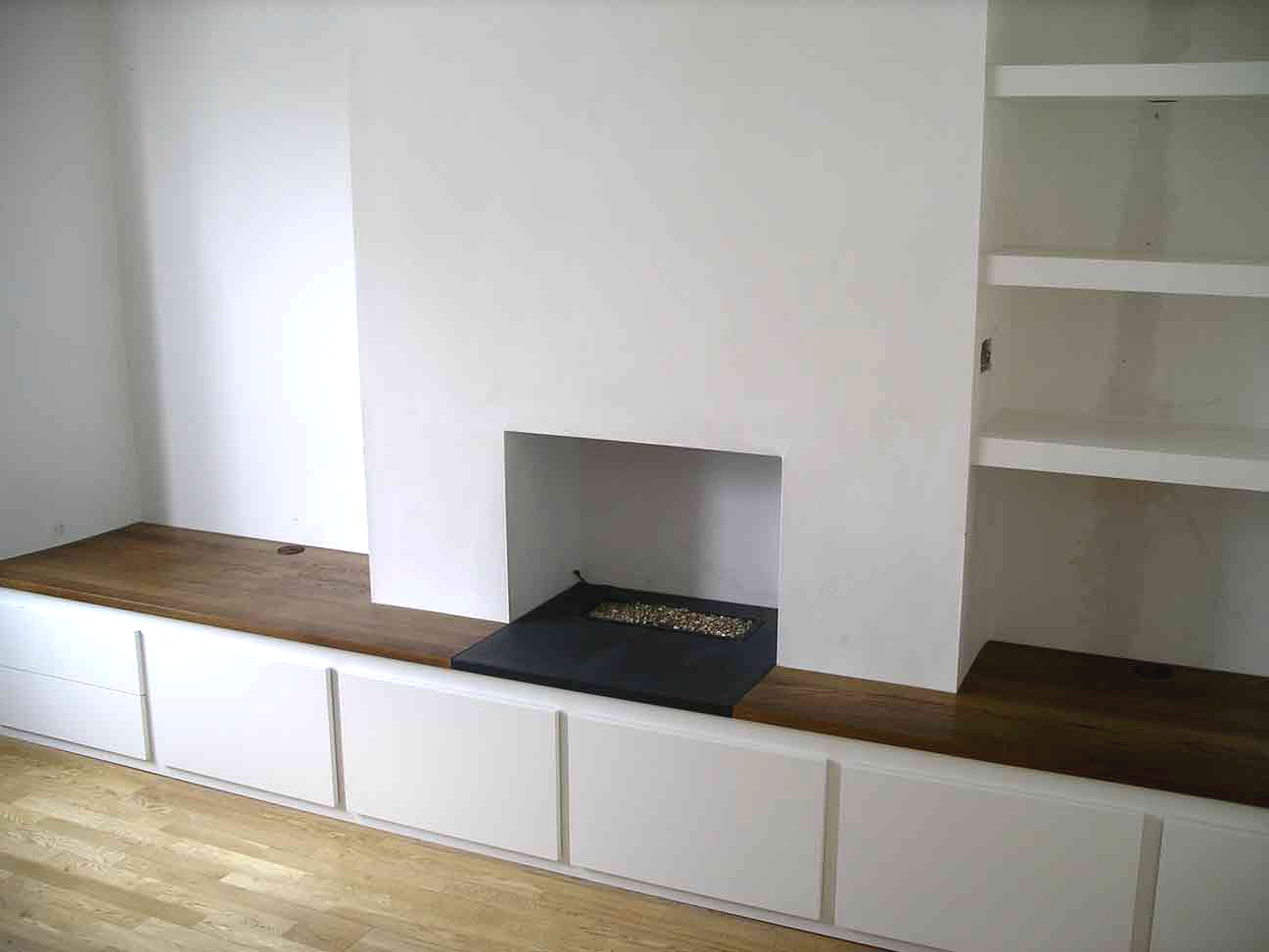 custom built cabinet spans chimney breast and alcoves